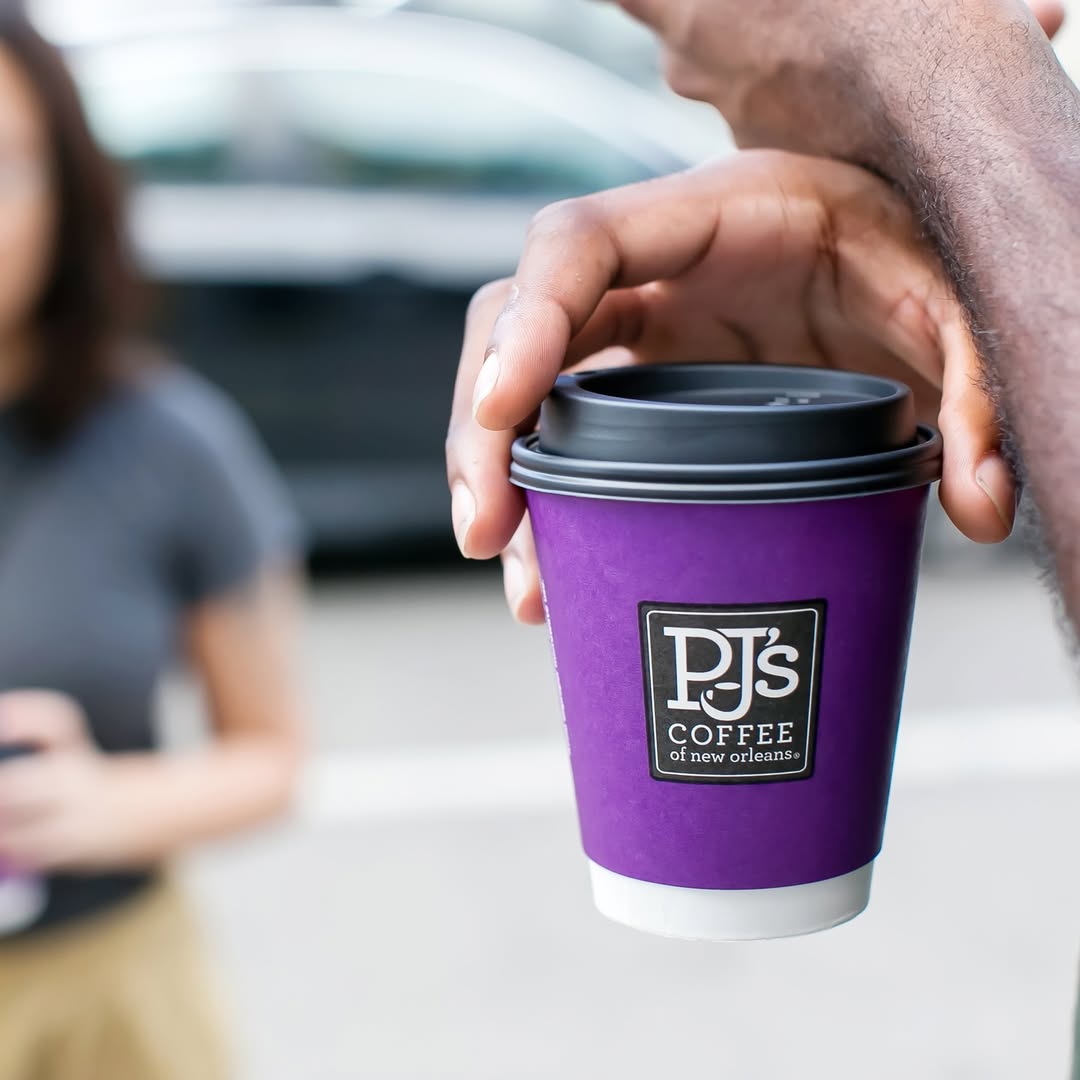 holding cup from PJ’s Coffee of New Orleans